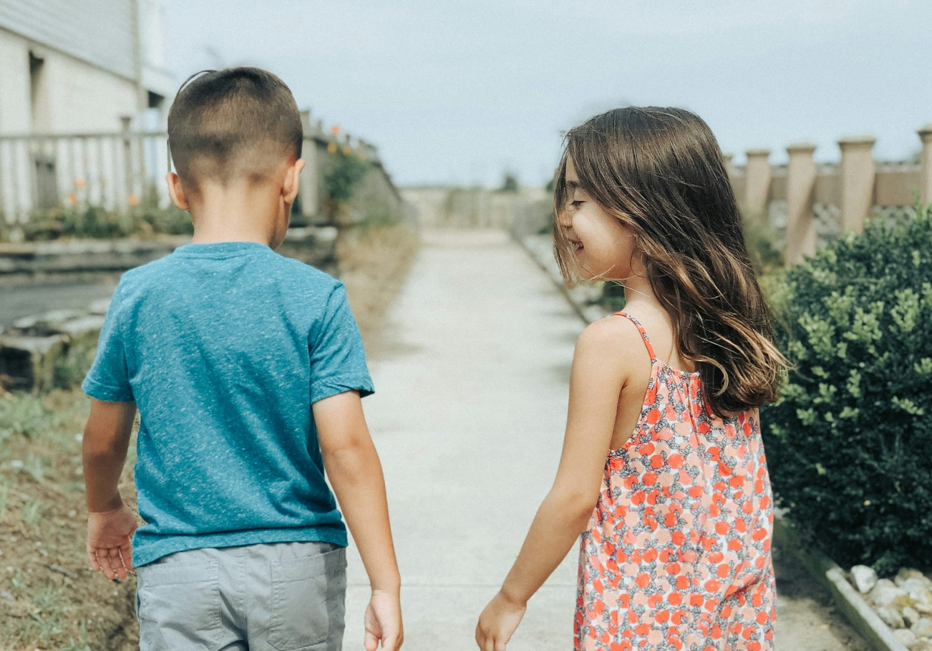 Two children walking together outdoors