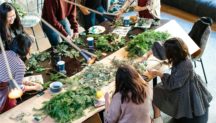 A group craft activity around a big table